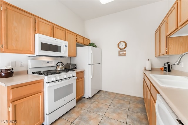 kitchen with sink, white appliances, light tile patterned floors, and light brown cabinets