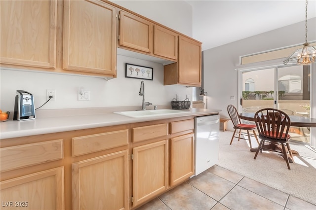 kitchen with light brown cabinetry, dishwasher, sink, decorative light fixtures, and light tile patterned flooring