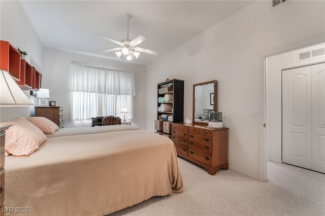 bedroom featuring ceiling fan, a closet, and light carpet