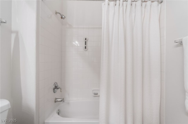 bathroom with shower / bath combo with shower curtain and toilet