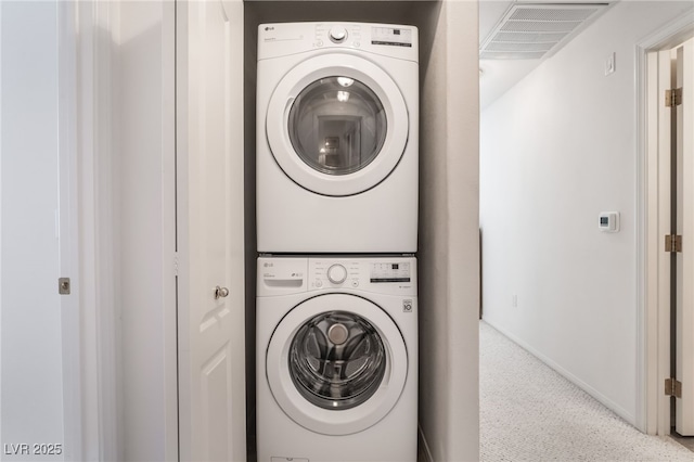 laundry room featuring stacked washer and clothes dryer