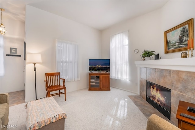 living room with a tiled fireplace