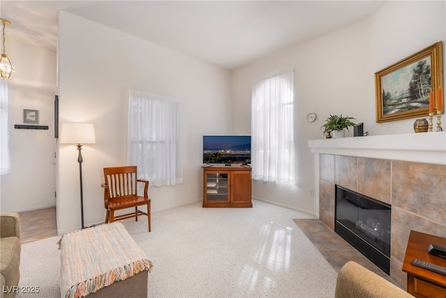 living room with a tiled fireplace