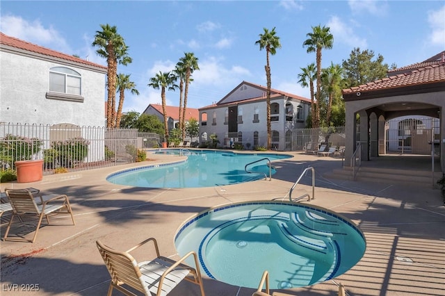 view of pool featuring a patio and a hot tub