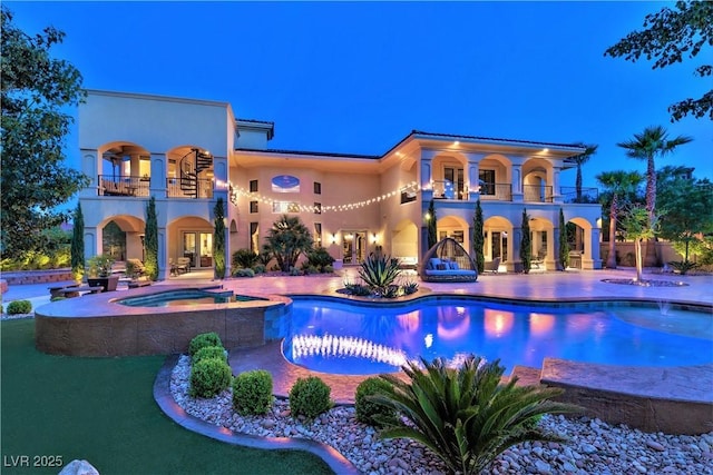 view of swimming pool with a patio and an in ground hot tub