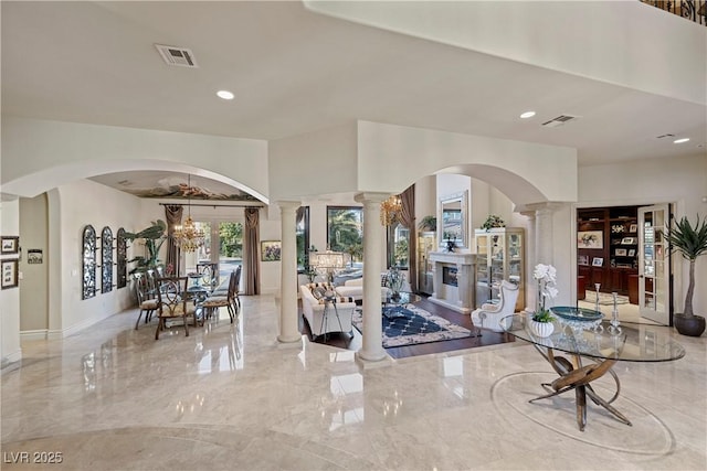 interior space with a chandelier and decorative columns