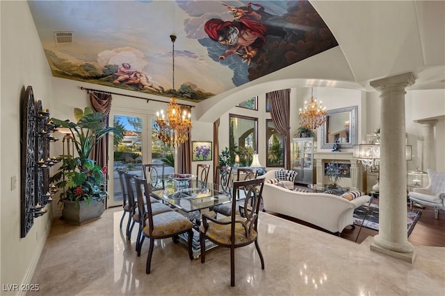 dining space featuring ornate columns and an inviting chandelier