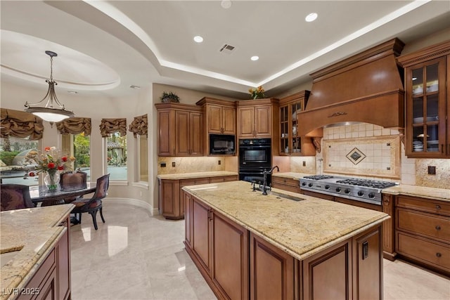 kitchen with decorative light fixtures, sink, black appliances, a raised ceiling, and custom range hood