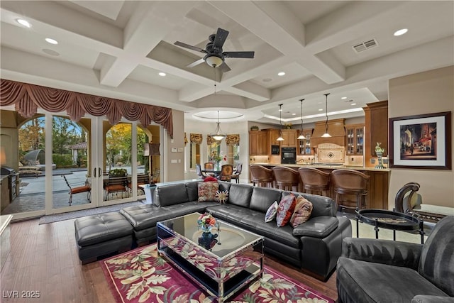 living room featuring beamed ceiling, coffered ceiling, dark hardwood / wood-style flooring, and french doors