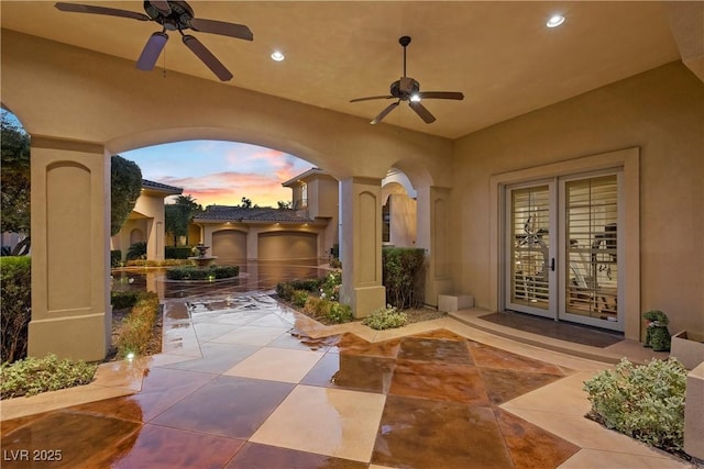 patio terrace at dusk with french doors and ceiling fan