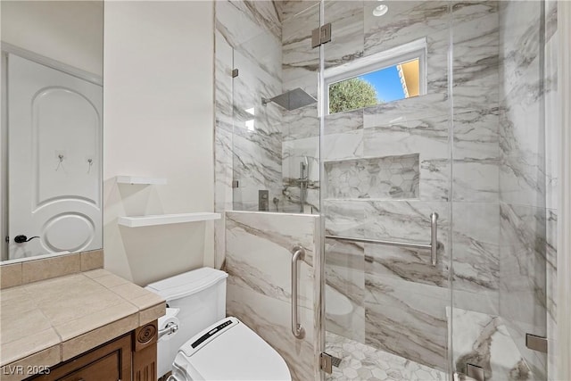 bathroom with vanity, an enclosed shower, and toilet