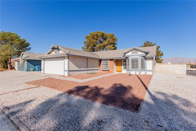 single story home with a garage and a mountain view