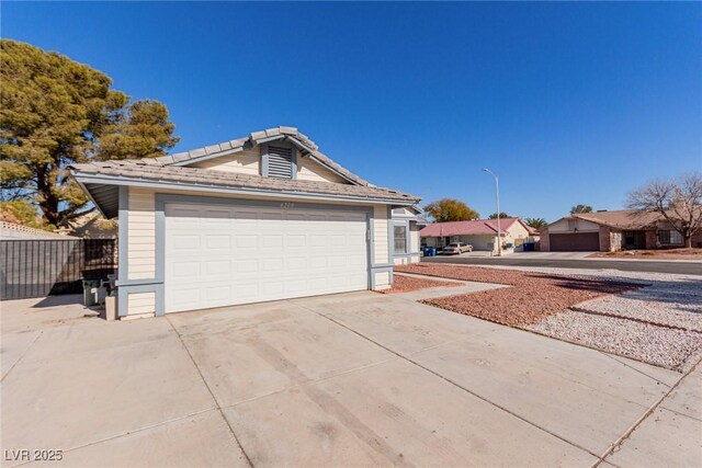 view of property exterior with a garage and an outdoor structure