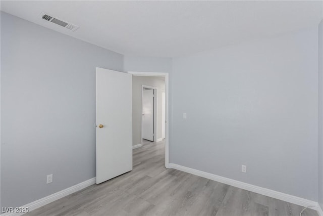 unfurnished room with light wood-type flooring