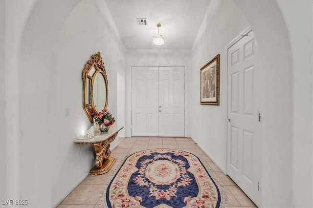 corridor with light tile patterned flooring