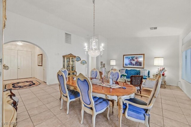 dining area featuring a chandelier and light tile patterned flooring