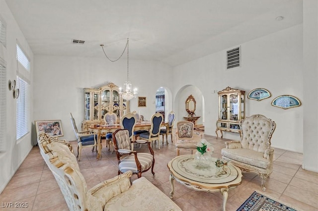 interior space with light tile patterned floors and a chandelier