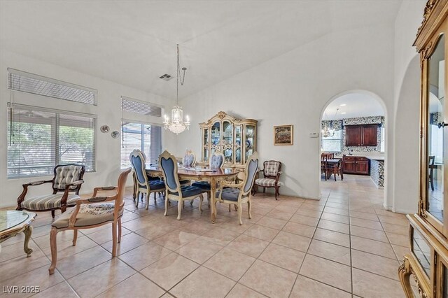 dining room featuring an inviting chandelier and light tile patterned flooring