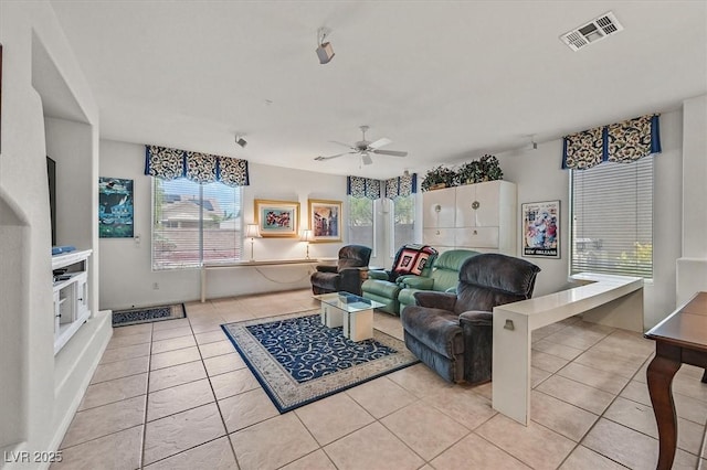 tiled living room with ceiling fan