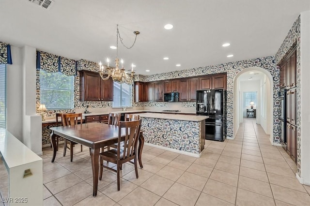 tiled dining area featuring an inviting chandelier