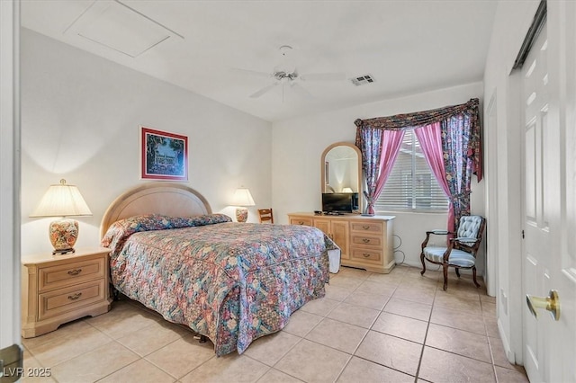 tiled bedroom with a closet and ceiling fan