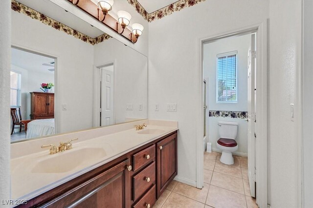 bathroom featuring tile patterned flooring, vanity, a chandelier, and toilet