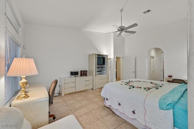 bedroom with light tile patterned flooring, ceiling fan, and high vaulted ceiling