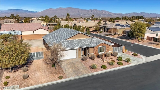 view of front of property featuring a garage and a mountain view