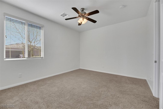 carpeted spare room with ceiling fan