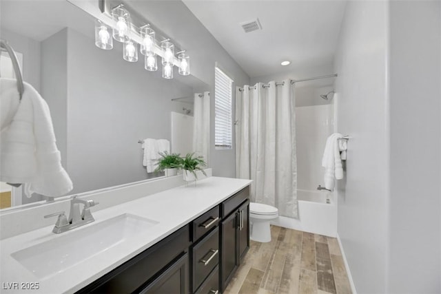 full bathroom with vanity, toilet, hardwood / wood-style floors, and shower / bath combo