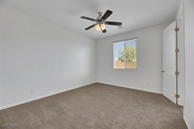 spare room featuring ceiling fan and carpet flooring