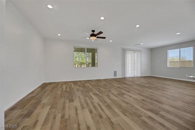 unfurnished room featuring ceiling fan and light hardwood / wood-style flooring