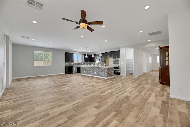 unfurnished living room featuring hardwood / wood-style floors and ceiling fan