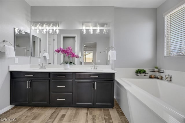 bathroom with hardwood / wood-style floors, a bathtub, and a healthy amount of sunlight