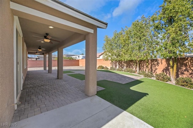 view of patio featuring ceiling fan