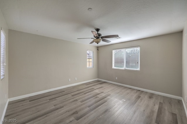 unfurnished room with ceiling fan and light hardwood / wood-style floors