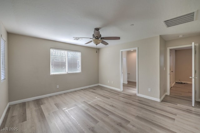 empty room with ceiling fan and light wood-type flooring