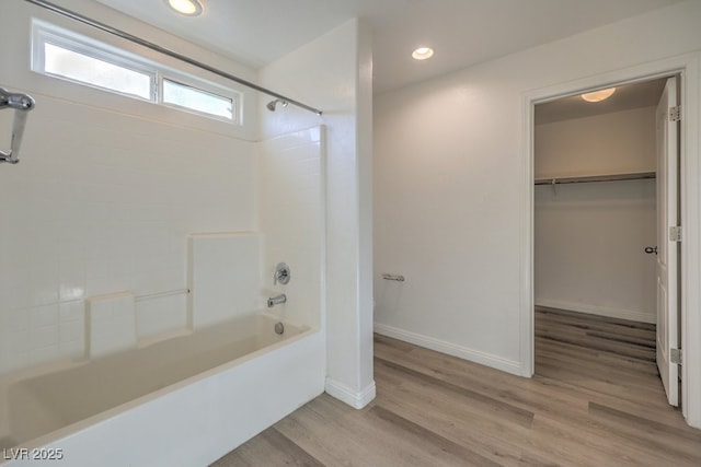 bathroom with hardwood / wood-style flooring and shower / bathtub combination