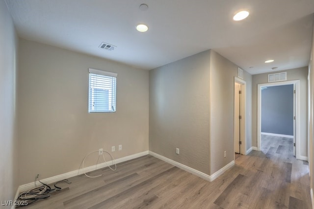 unfurnished room with hardwood / wood-style flooring