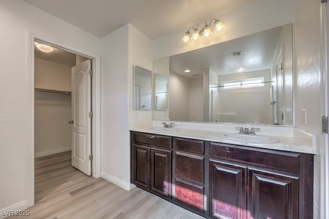 bathroom with vanity and hardwood / wood-style flooring