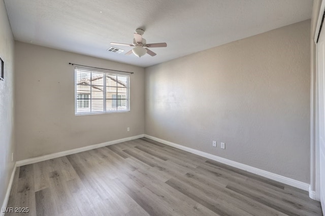 spare room featuring ceiling fan and light wood-type flooring