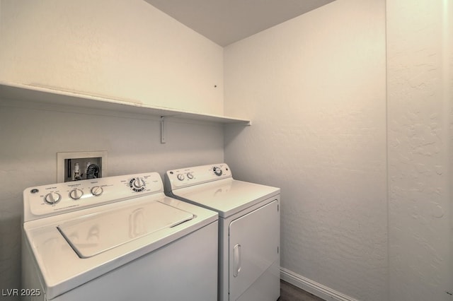 clothes washing area with dark hardwood / wood-style flooring and washer and clothes dryer