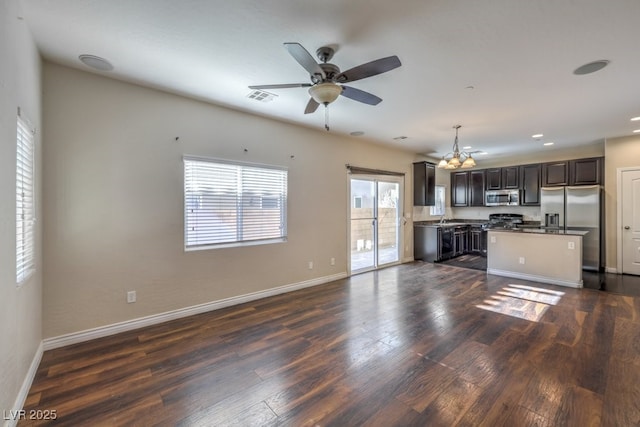 kitchen featuring sink, decorative light fixtures, dark hardwood / wood-style floors, ceiling fan, and stainless steel appliances