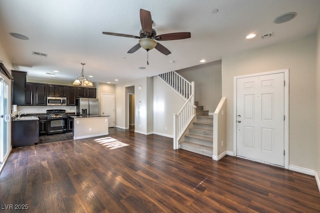 kitchen with appliances with stainless steel finishes, dark hardwood / wood-style floors, pendant lighting, and ceiling fan