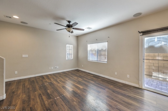 spare room featuring dark hardwood / wood-style flooring and ceiling fan