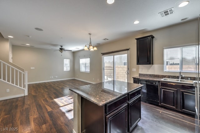 kitchen featuring sink, decorative light fixtures, dark hardwood / wood-style floors, dishwasher, and a kitchen island