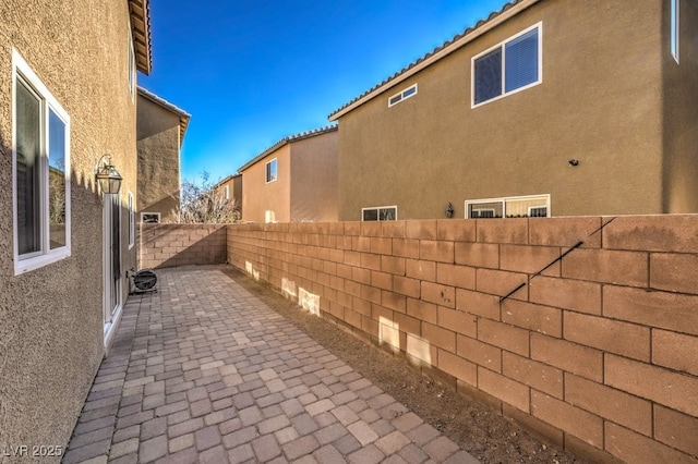 view of side of home featuring a patio