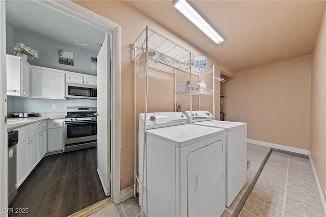 laundry room with washing machine and dryer and wood-type flooring