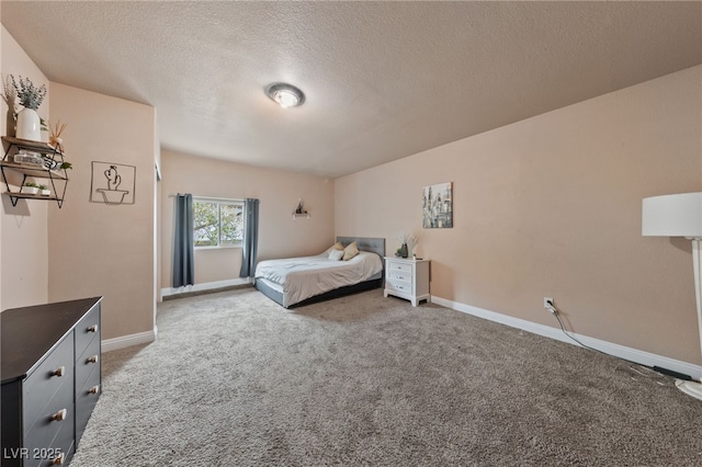 bedroom with carpet floors and a textured ceiling