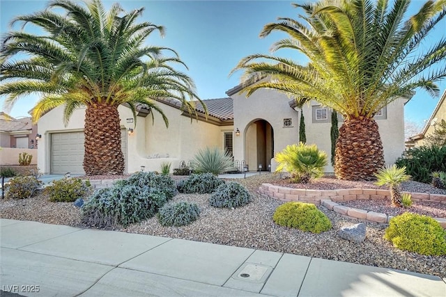 mediterranean / spanish home with a garage